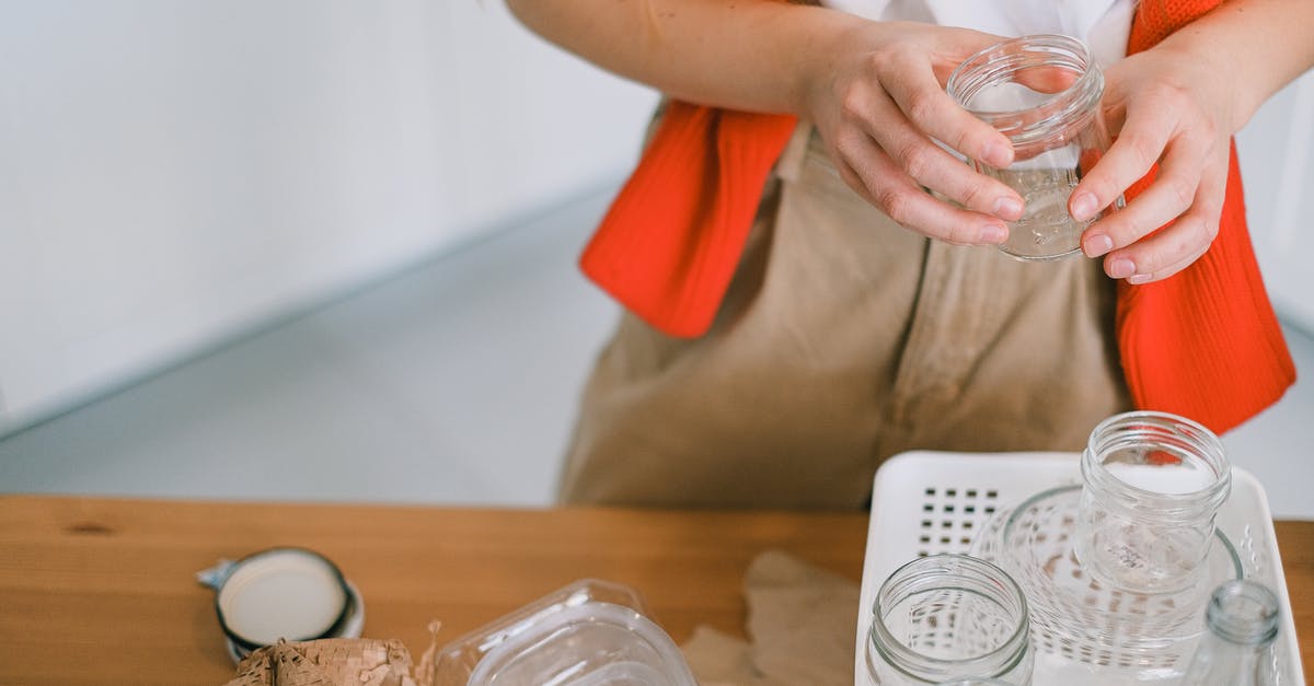 If I collect my resources, will it reduce any loss from attacks? [duplicate] - Crop anonymous female in casual clothes standing with glass jar near table while sorting out paper plastic and glass rubbish for recycling