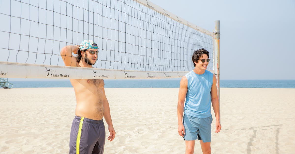If I have two discs for Minecraft on the XBOX, will it get confused? - Two Men Standing by Volleyball Net on Beach