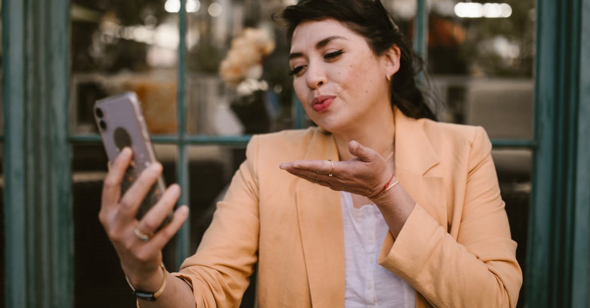 If I paid for Super Mario Run on one ecosystem, will I have access to the paid features on another? - Woman in Brown Blazer Holding Smartphone If I paid for Super Mario Run on one ecosystem, will I have access to the paid features on another? - Woman in Brown Blazer Holding Smartphone
