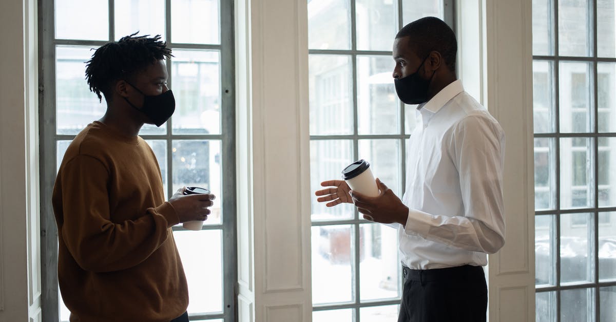 If I respawn a boss and kill him with Lucatiel again, does that count towards the 3 bossfight requirement to prevent her from disappearing? - Side view of ethnic male director in fabric mask with coffee to go talking to employee while looking at each other indoors