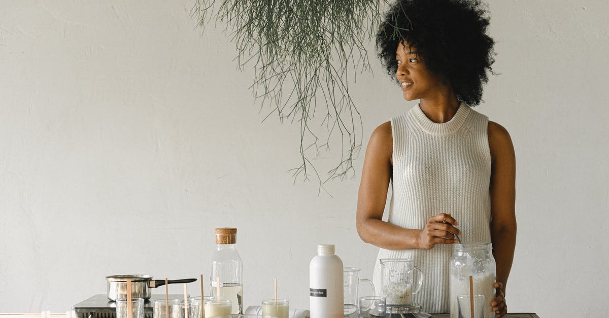 If I scrap a locked safe, does its content go to the workshop? - Content African American female artisan with jar of wax flakes looking away while creating candles in modern workshop in light room