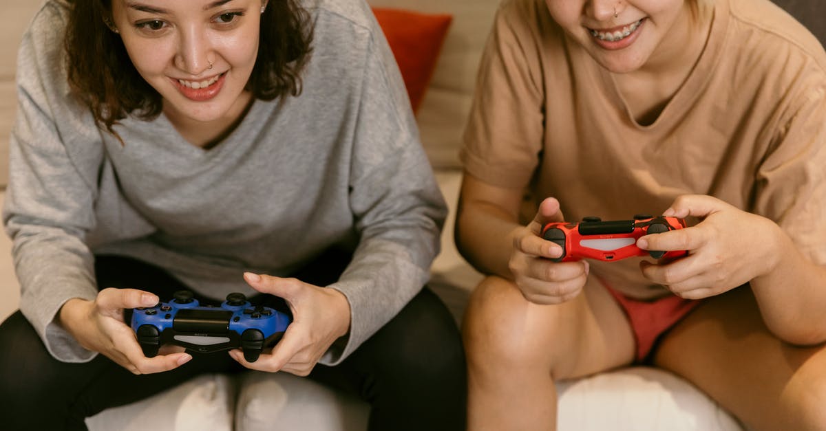 If multiple accounts own different DLCs for a game, can every account in the console use them? - Crop Asian girlfriends playing video games at home
