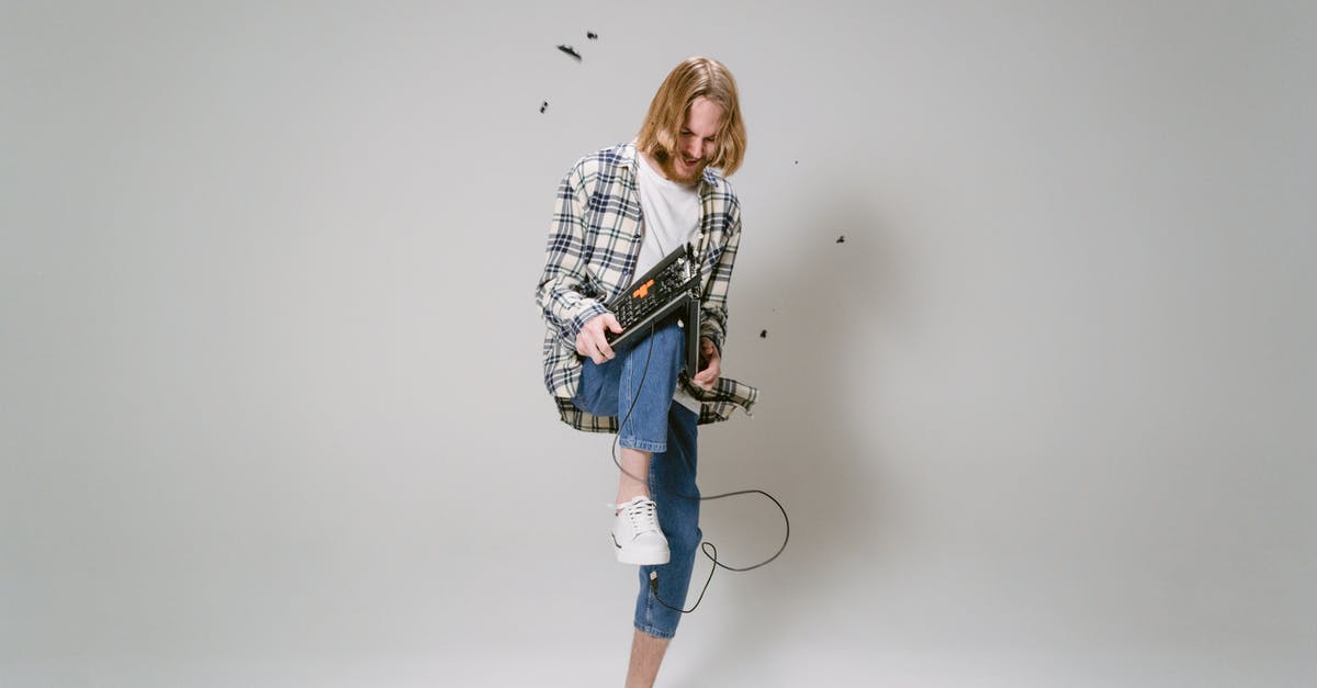 If my Pokemon faints, does it break my chain? - Woman in White and Black Checkered Long Sleeve Shirt and Blue Denim Shorts Holding Black and If my Pokemon faints, does it break my chain? - Woman in White and Black Checkered Long Sleeve Shirt and Blue Denim Shorts Holding Black and