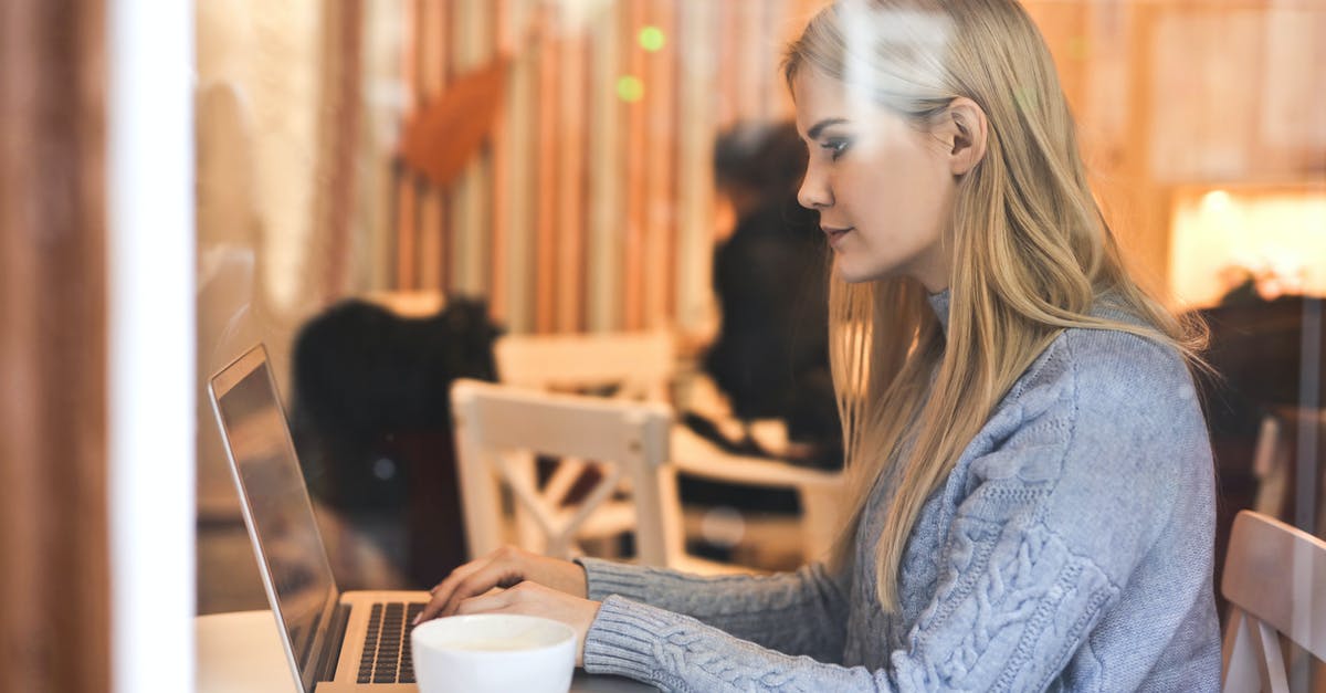 In an online hacking mission, how do I check for people in cars? - Serious young woman using netbook while having hot drink in modern cafe