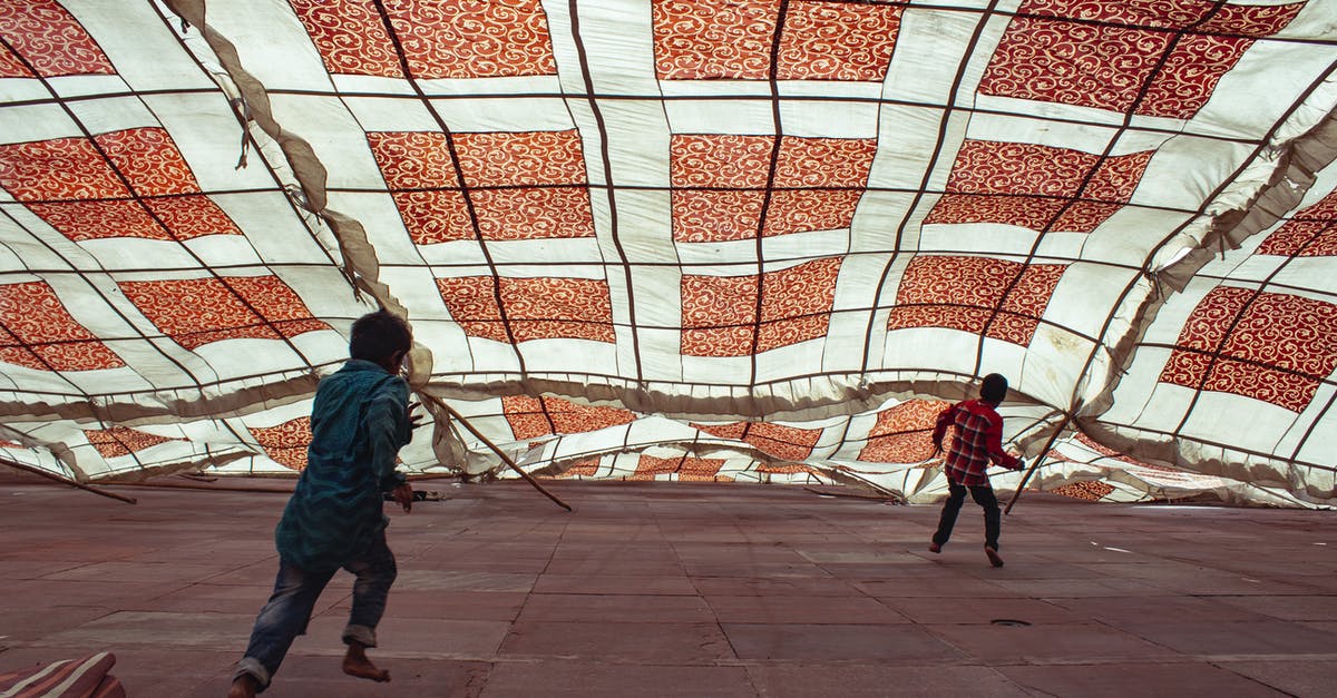 In Atomas, what determines the next element a player receives? - Man in Blue Jacket Walking on Gray Concrete Pavement