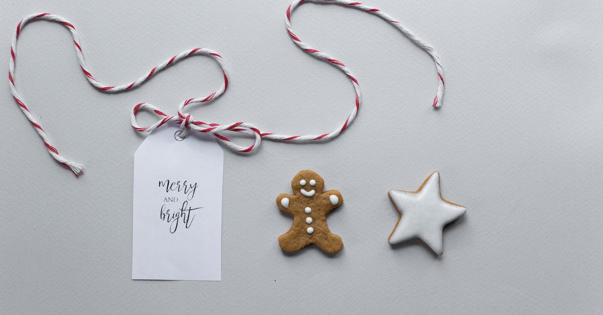 In Cut the Rope 2, what do I do after finding a hidden star in a video? - Overhead composition of handmade gingerbread man and star cookies covered with icing placed near gift tag with string and inscription Merry And Bright