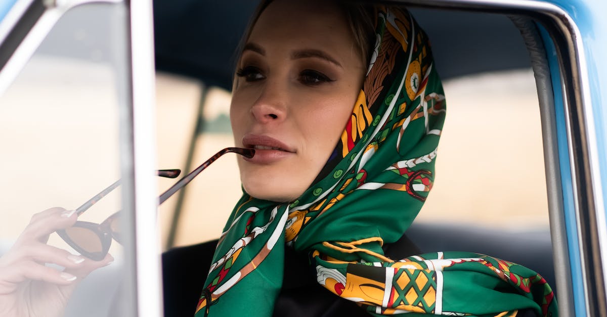 In GTA 4, does driving a particular vehicle make it appear more often? - Thoughtful female in stylish clothes and headscarf driving retro car and pensively looking away in daytime In GTA 4, does driving a particular vehicle make it appear more often? - Thoughtful female in stylish clothes and headscarf driving retro car and pensively looking away in daytime