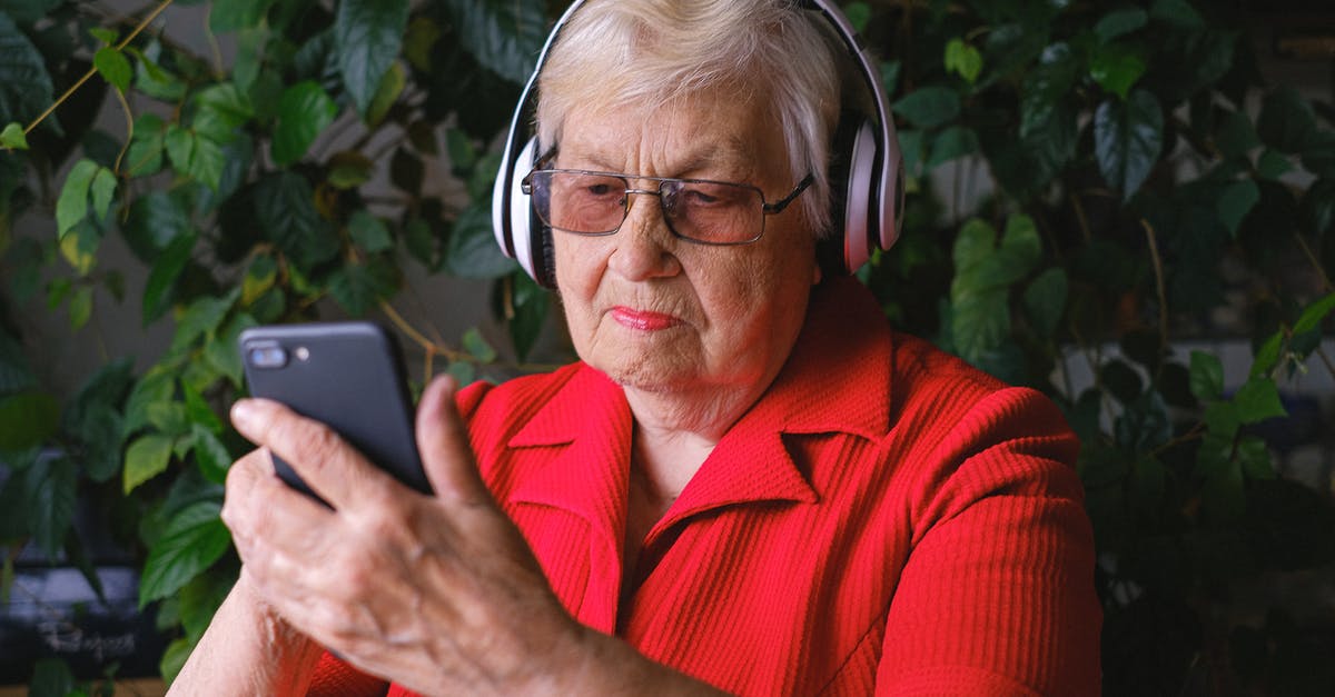 In Level 5-3, where do I use the final red key? - Focused aged woman browsing smartphone while listening to song