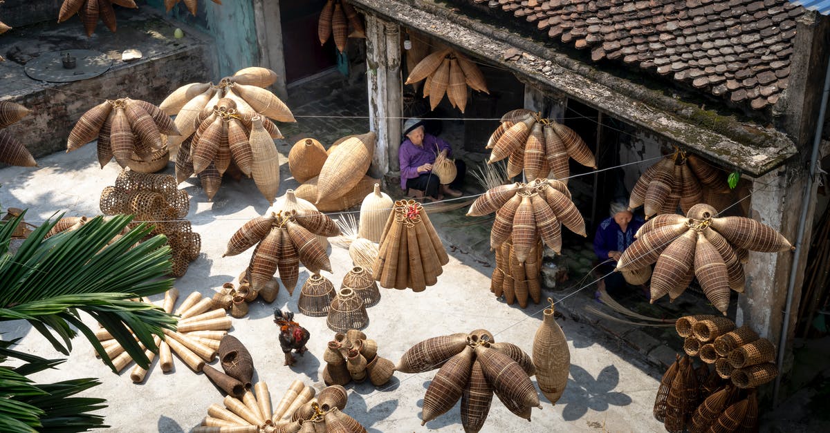 In MCPE v.0.15.2 can you trade with villagers? - From above of people sitting and making bamboo fish traps while working on local bazaar in Vietnam in daylight