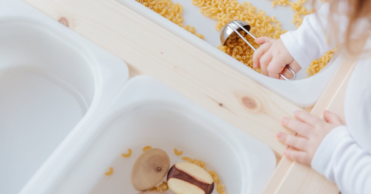 In the game Trove, how do you get recipes for the Haunted Workbench? - Little girl collect raw pasta with metal spoon in plastic container In the game Trove, how do you get recipes for the Haunted Workbench? - Little girl collect raw pasta with metal spoon in plastic container