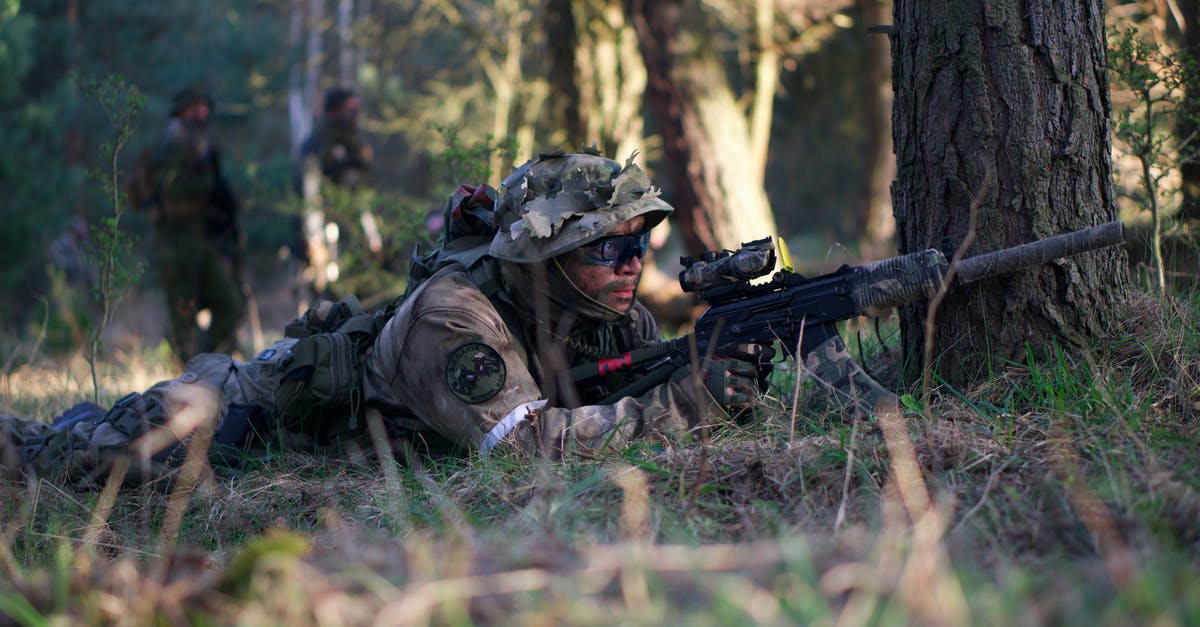 In War of the Chosen, are Chosen Stronghold missions "urgent"? - Man in  Camouflage Jacket Lying on Green Grass Field