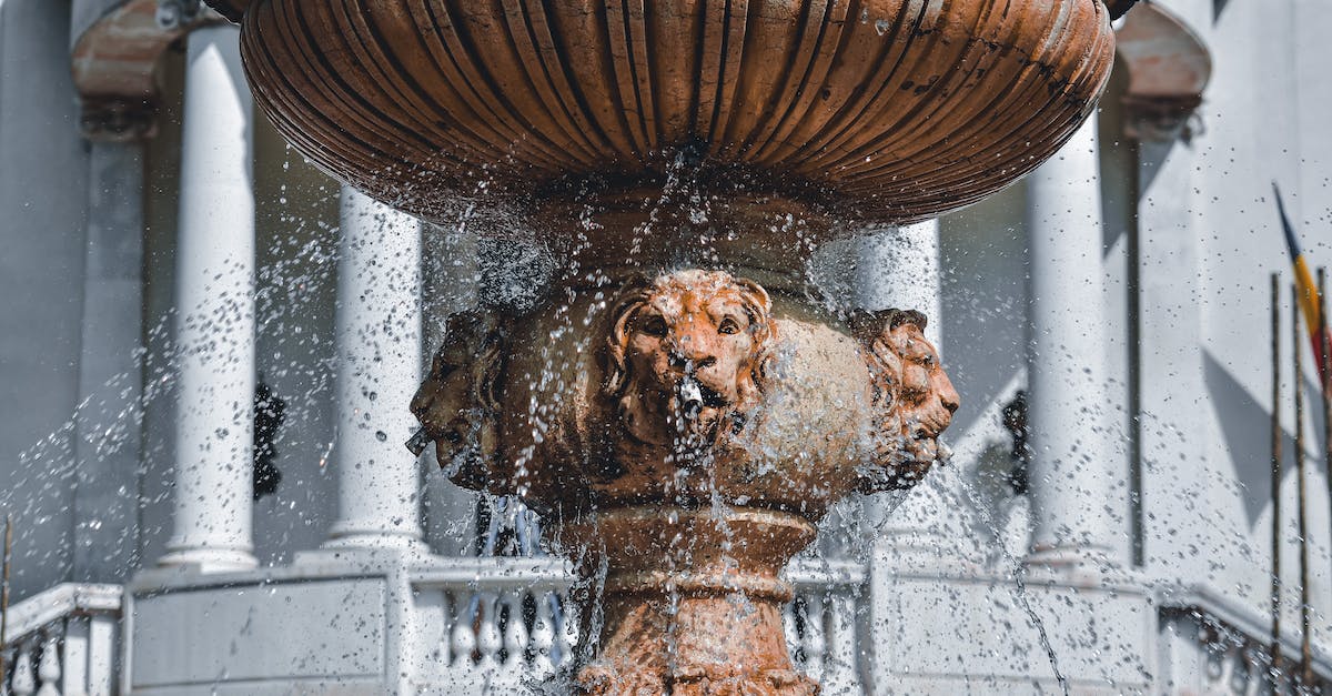 In what column is an item dropped? - Old fountains with splashing drops of clean water near building with white columns