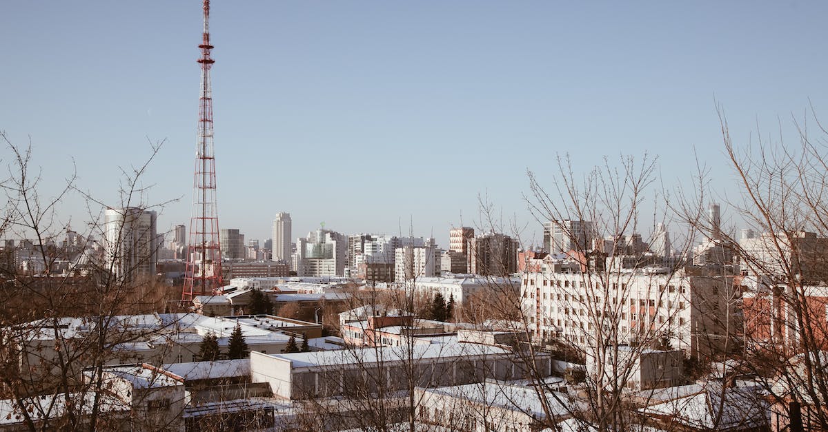 Increase population with Radio Station / Advantage over pregnancy? - Modern buildings and transmission tower in city Increase population with Radio Station / Advantage over pregnancy? - Modern buildings and transmission tower in city