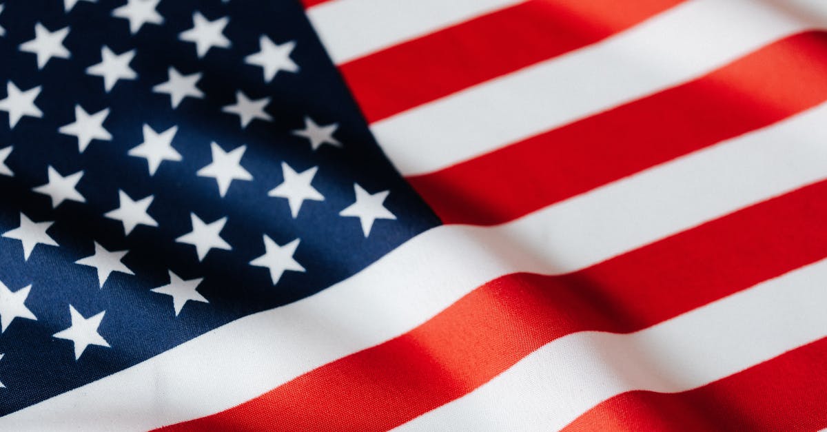 Inefficient Planetary Administration Influence Modifier - From above of closeup flattering national flag of USA with white and red stripes and stars on blue background
