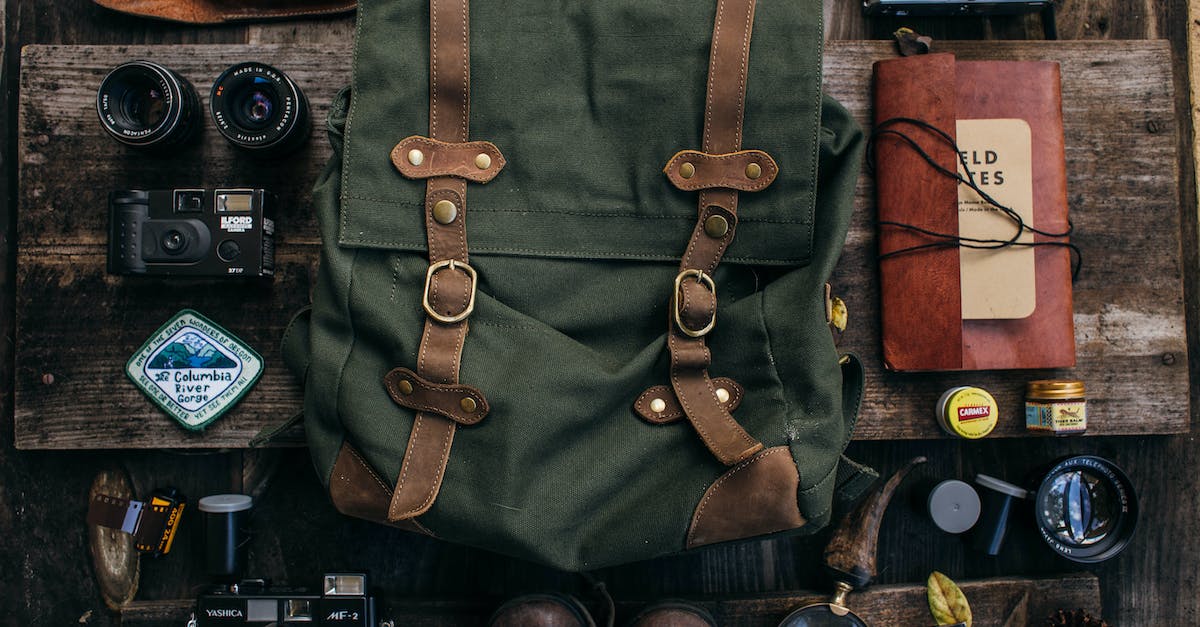 Infinite item source for creative mode? - Overhead of backpack near vintage photo cameras near lenses and camera roll near shoes and notebook near knife placed on table