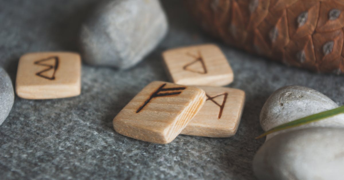 Infusing with faint stone vs. Infusing with Magic stone? - Wooden runes and stones scattered on wool plaid