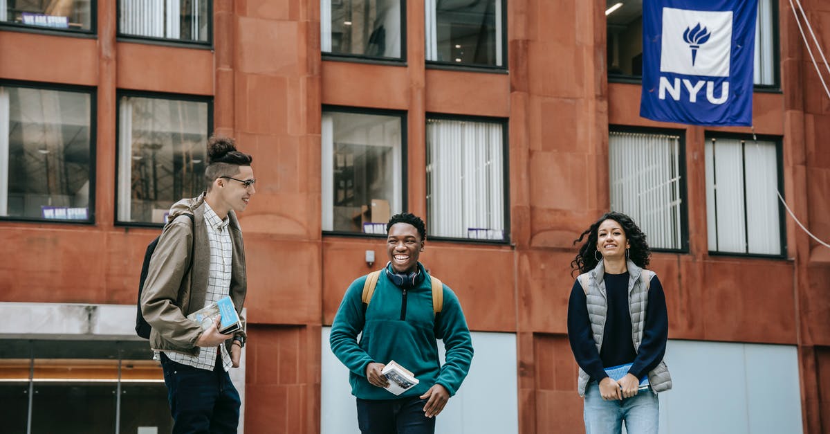 Ingress factions: only appears to be one group in my city - Group of cheerful multiethnic friends in casual outfit smiling near modern building of university with flag Ingress factions: only appears to be one group in my city - Group of cheerful multiethnic friends in casual outfit smiling near modern building of university with flag
