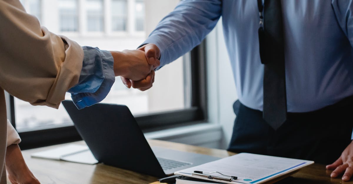 Installing Minecraft mods without a bin folder or minecraft.jar [duplicate] - Crop unrecognizable coworkers in formal wear standing at table with laptop and documents while greeting each other before meeting