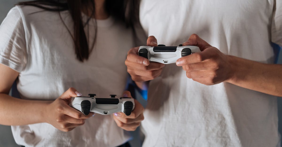 Invading a friend while he is playing - People in White Shirt Holding Black and White Game Controllers