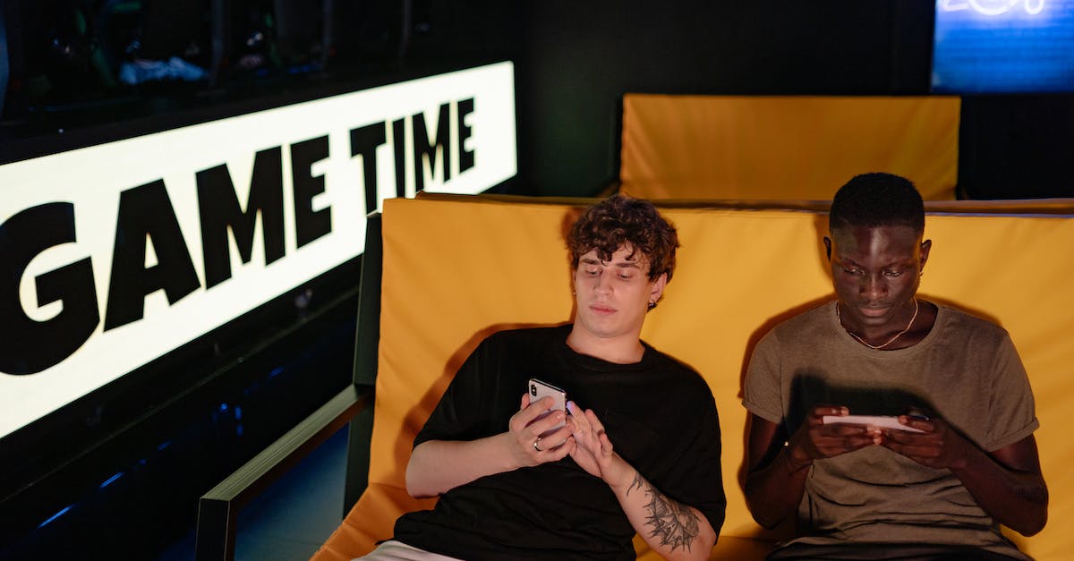 Invading a friend while he is playing - Man in Black Crew Neck T-shirt Sitting Beside Man in Black Crew Neck T-shirt