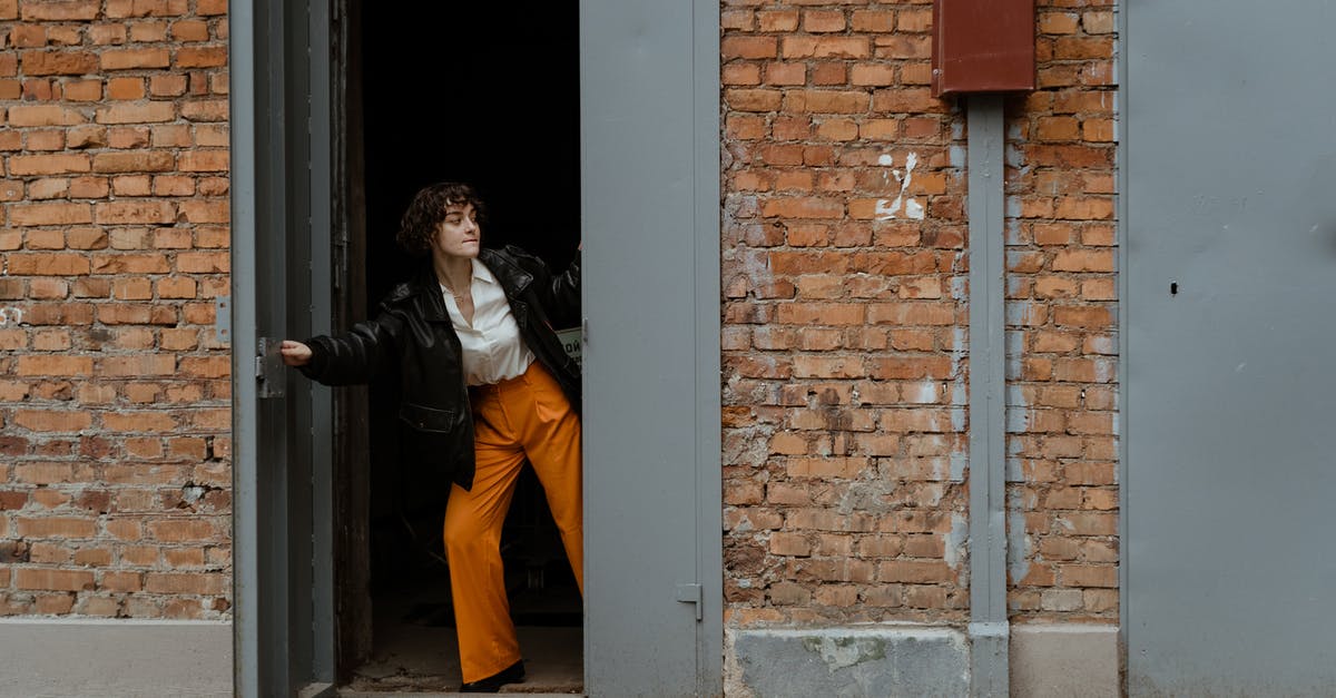 Inventory opening and closing - Photo of a Woman Closing a Gray Door