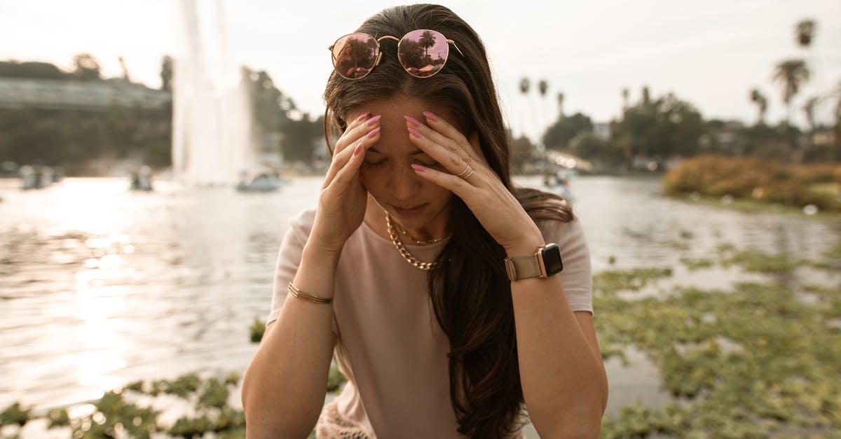 Is 'snecko eye' a bad choice without 2-cost cards? - Distressed woman sitting on lakeside and touching face in despair