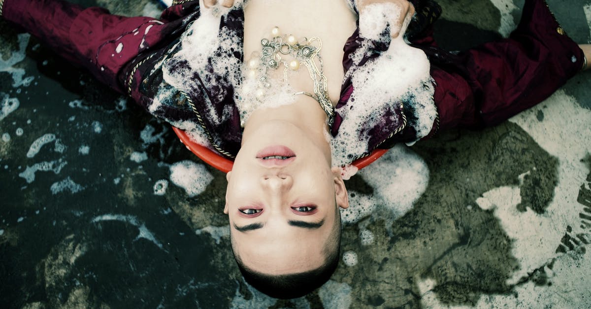 Is a pokemon's gender determined before it hatches from its egg? - Top view of unrecognizable person touching young male model covered with white foam and lying on concrete ground