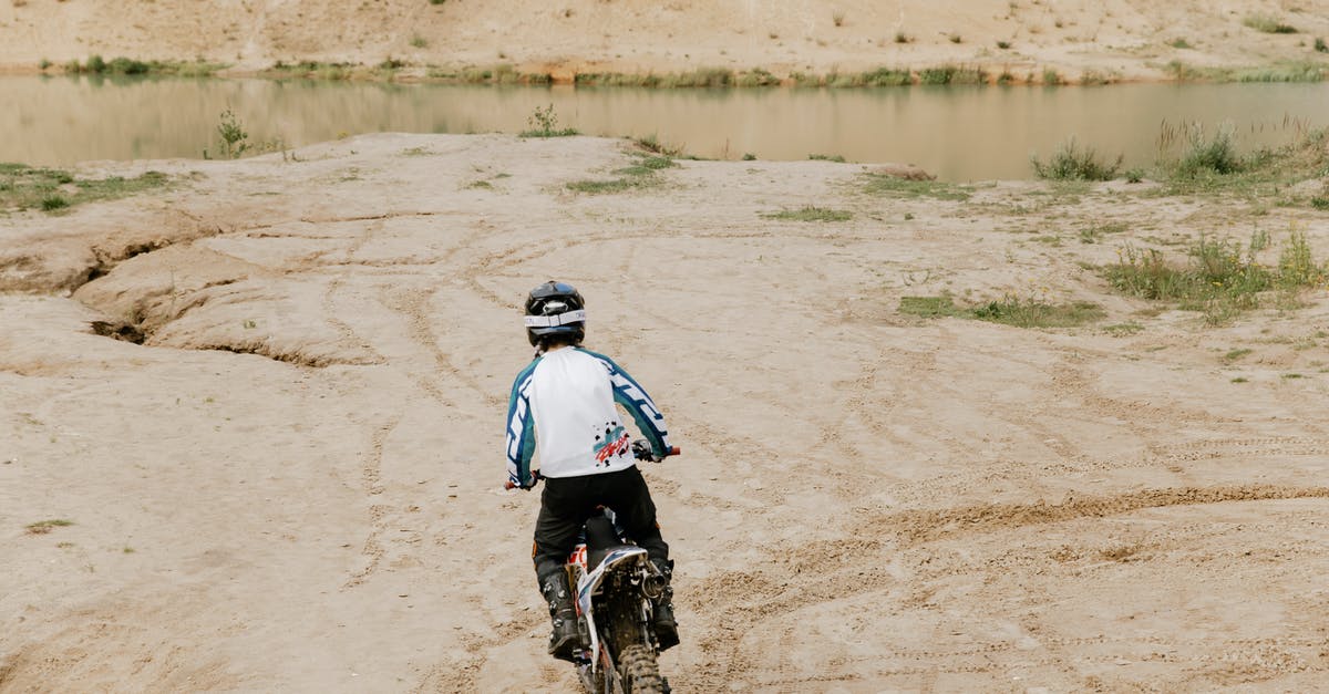 Is a ramming vehicle better off with a shield or an A.I.D.? - Person Riding a Motorbike on Dirt Road