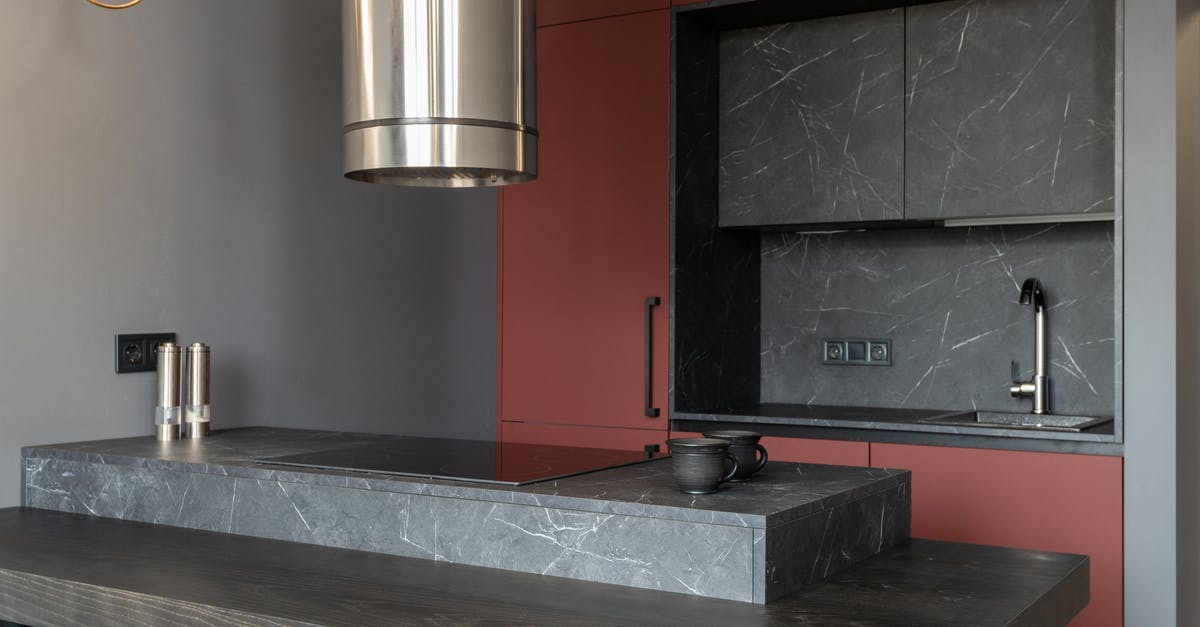 Is appropriating an already built structure a valid strategy? - Modern interior design of small open plan kitchen furnished with cupboards and marble island counter with built in appliances and tube hood