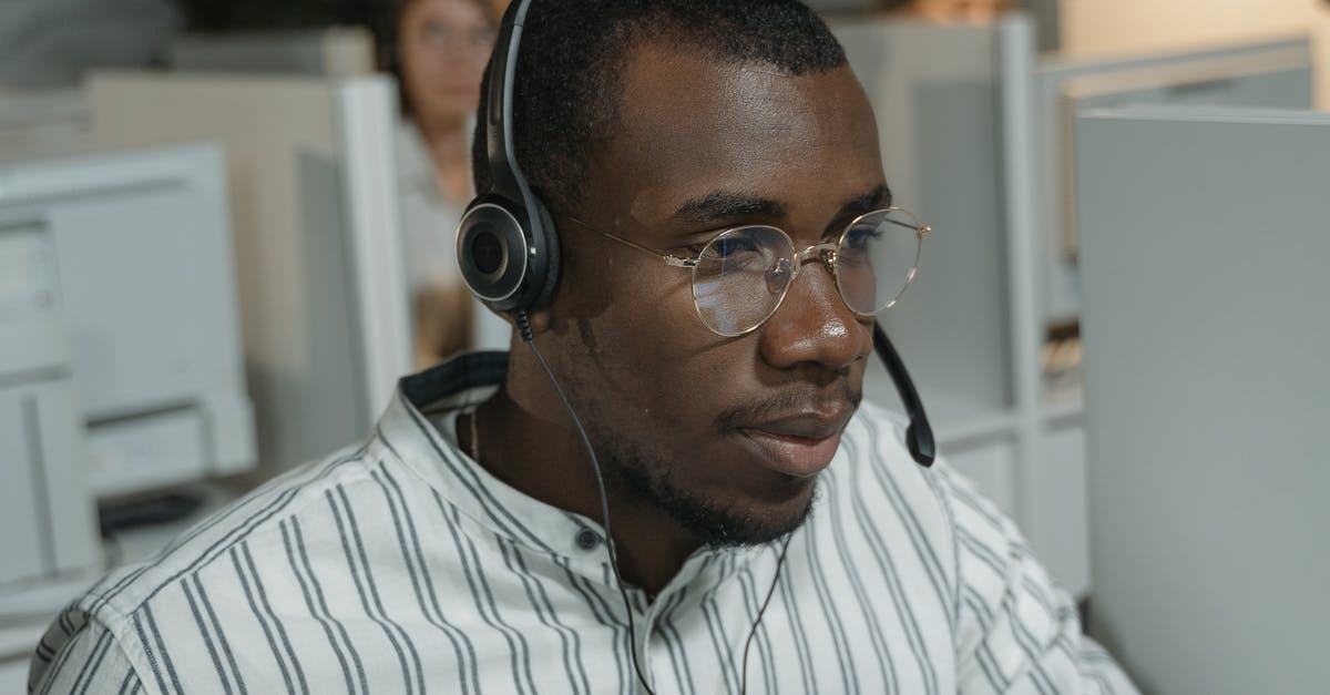 Is Call of Duty: Ghosts backwards compatible? - Man in White and Black Striped Button Up Shirt Wearing Black Headphones
