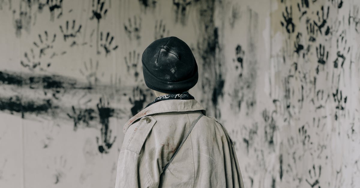 Is Chara actually evil? - Person in Brown Coat and Black Hat Standing Near White and Black Floral Wall