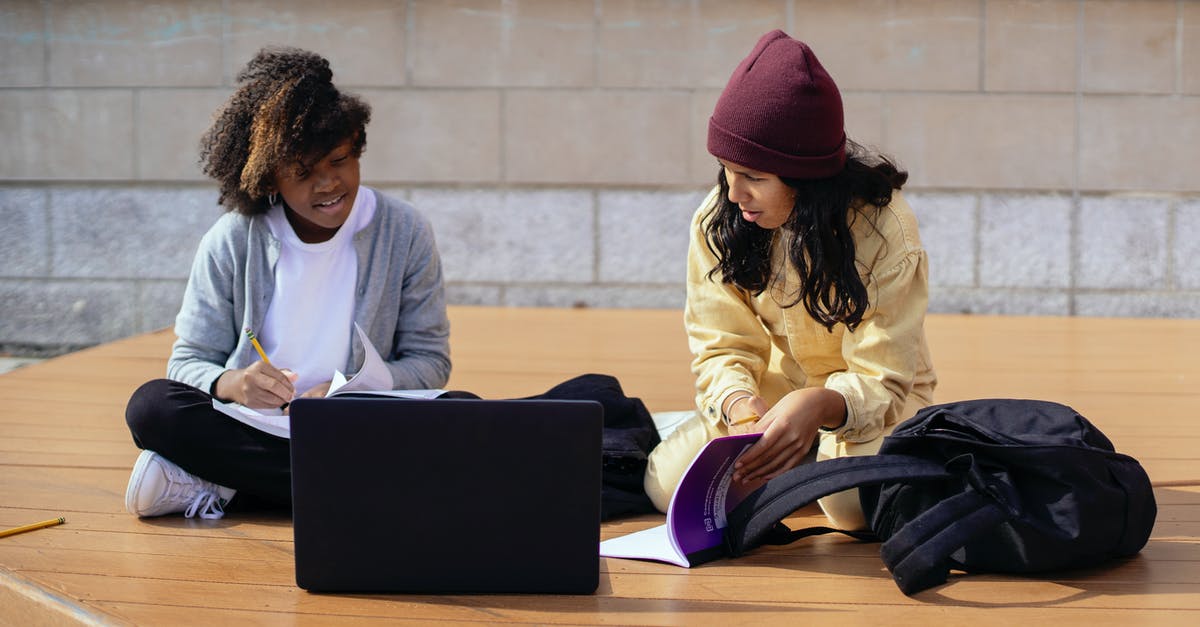 Is Clash cross platform multiplayer without account transfer? - Diverse schoolgirls talking while studying near laptop on street