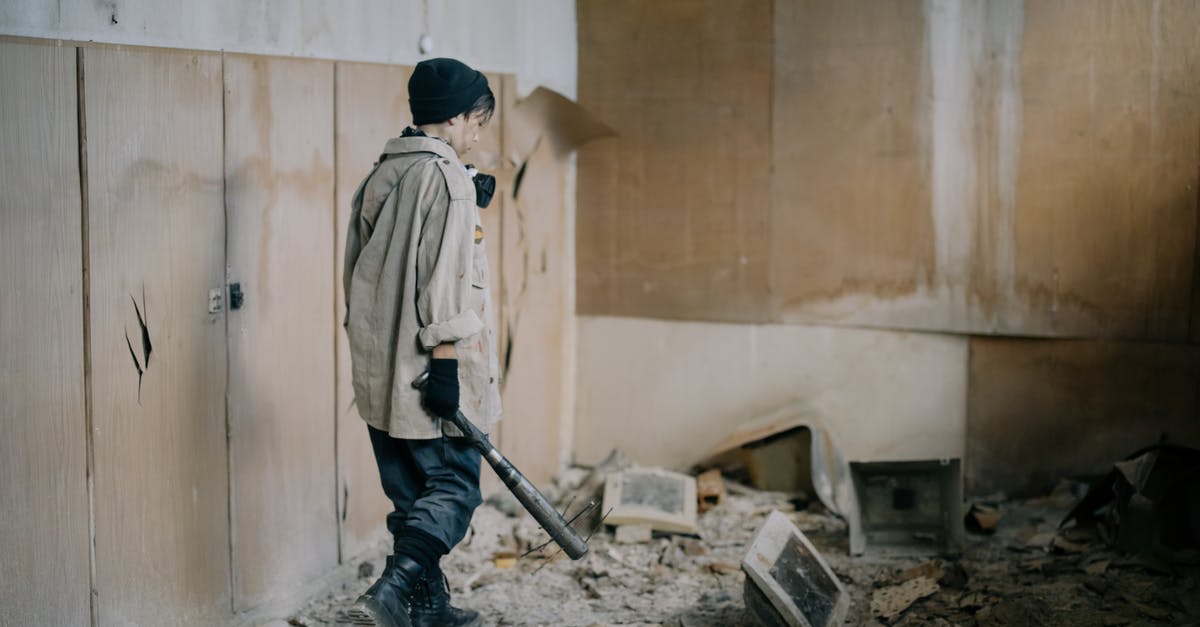 Is Defense Damage Reduction? - Man in White Dress Shirt and Black Pants Holding Black Metal Stick Is Defense Damage Reduction? - Man in White Dress Shirt and Black Pants Holding Black Metal Stick