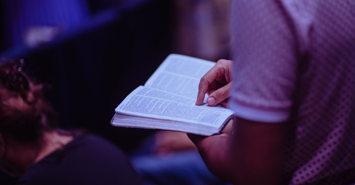 Is Heretic 2 anyway connected to the Hexen series? - Selective Focus Photo of Person Holding Book