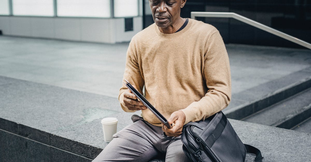 Is it a bug if my bag and my journal are contradicting? - Mature black businessman with folder in street