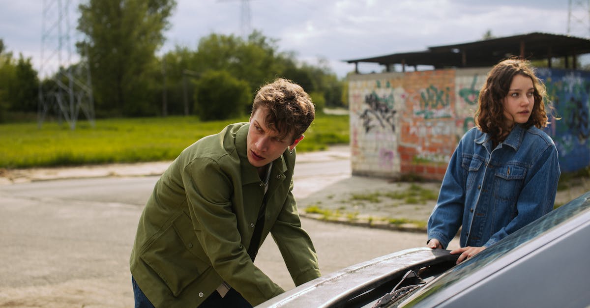 Is it bad to murder the witch with the cottage? - Man in Green Jacket and Blue Denim Jeans Standing Beside Car Is it bad to murder the witch with the cottage? - Man in Green Jacket and Blue Denim Jeans Standing Beside Car