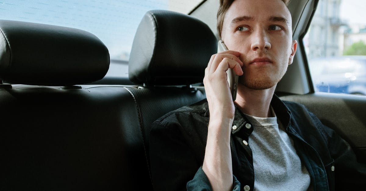 Is it considered cheating if one plays Pokémon GO while being a passenger in someone&rsquo;s car? - Man in Gray Button Up Shirt Sitting on Black Leather Car Seat