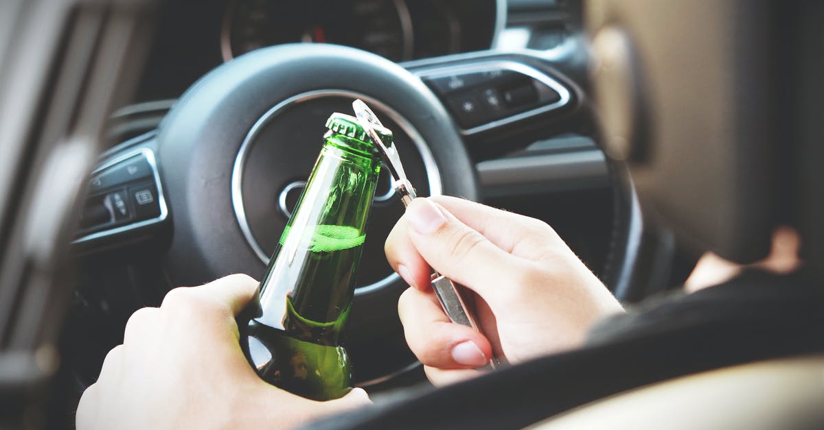 Is it dangerous to leave my car idling while I sleep in a garage? - Person Opening Bottle on Car Is it dangerous to leave my car idling while I sleep in a garage? - Person Opening Bottle on Car