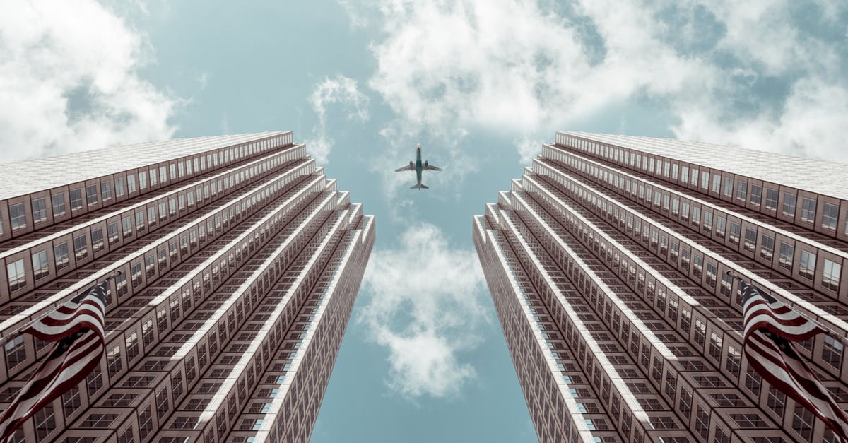 Is it easier to beat a Pokemon that's twice as high at low or high CP values? - Worm's-eye view Photo of Plane Between Two High-rise Buildings