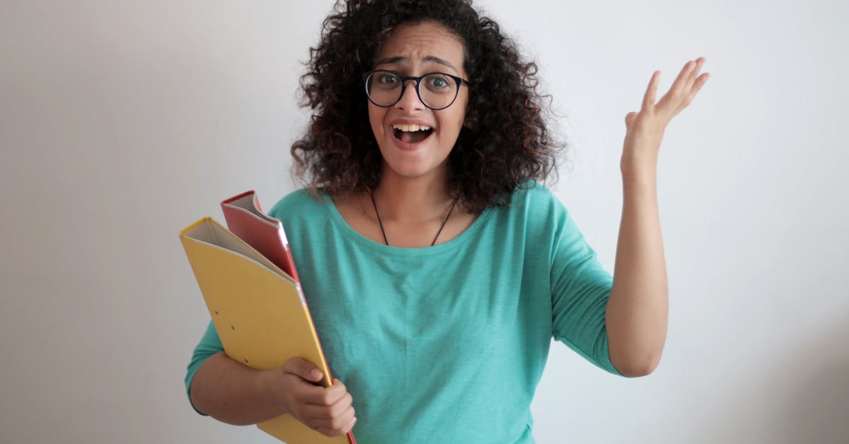 Is it necessary to do Fake Papers after getting sufficiently far enough in Family Matters? - Dissatisfied annoyed woman with mouth opened wearing glasses and turquoise blouse looking away and screaming while standing against white wall with folders of documents and having problems in work