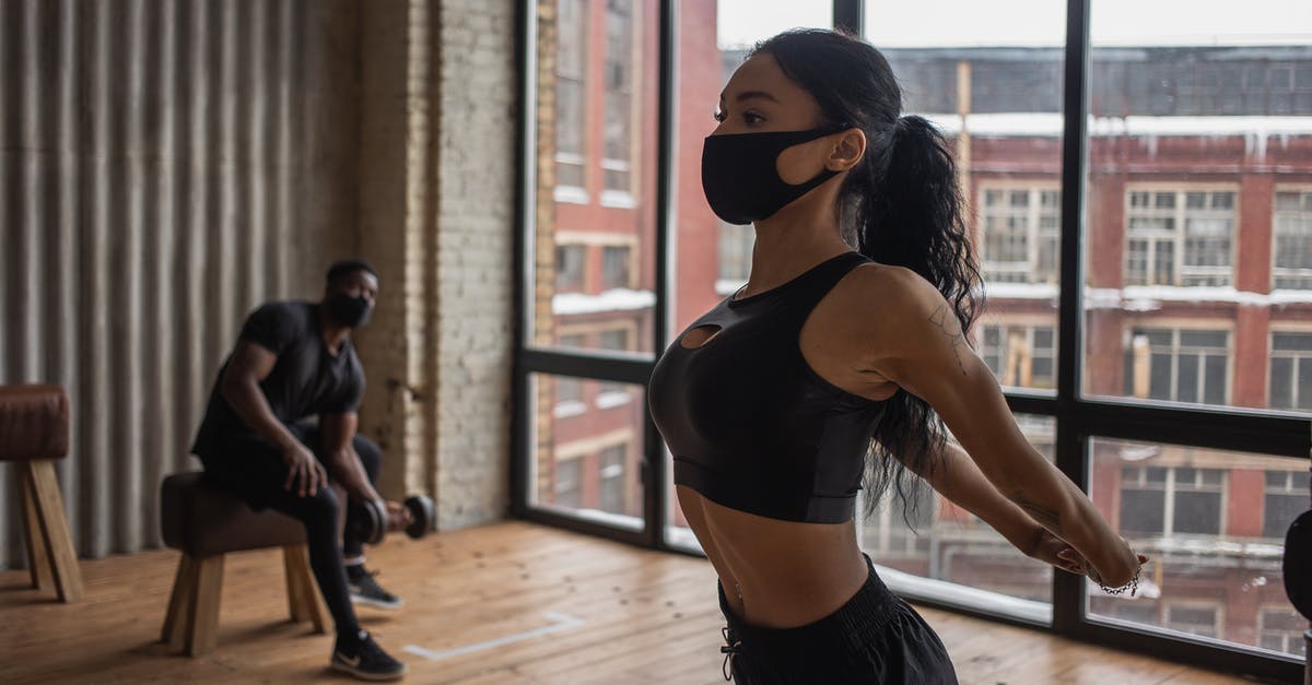Is it normal to have 12 activated Thin Men on month 3 on Impossible difficulty? - Fit African American sportswoman in mask stretching arms while training in gym during coronavirus pandemic with man lifting dumbbell Is it normal to have 12 activated Thin Men on month 3 on Impossible difficulty? - Fit African American sportswoman in mask stretching arms while training in gym during coronavirus pandemic with man lifting dumbbell