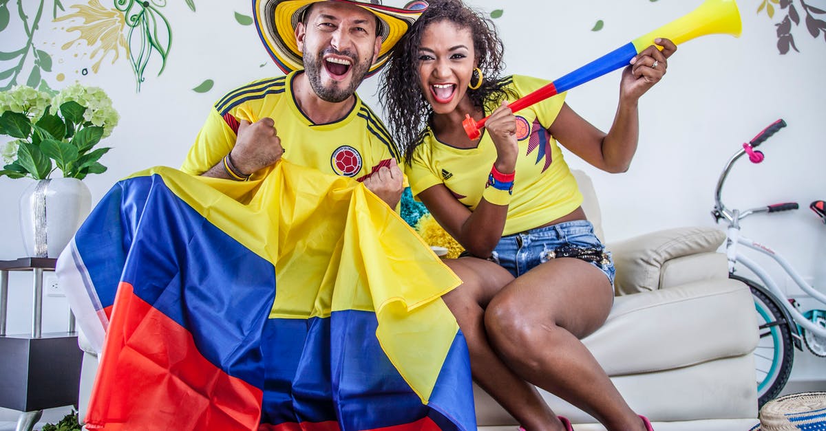 Is it normal to have a 'Can't keep up' event on reload? - Excited ethnic couple with Colombian flag and toy pipe