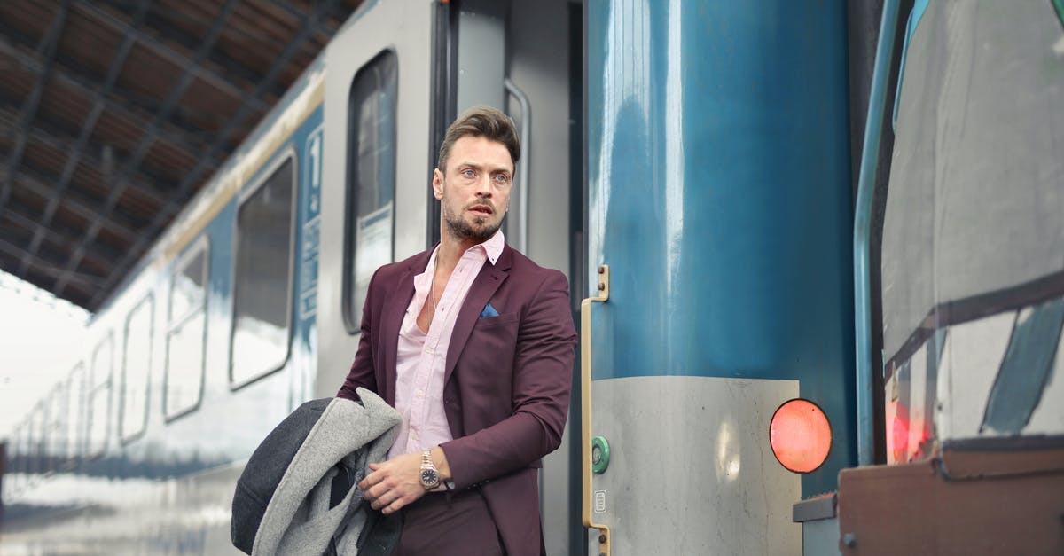 Is it possible for a 3ds to act as the source and destination of system transfers without having to wait 7 days in between? - Serious bearded male passenger in stylish suit standing near train with travel bag and coat in hand and looking away