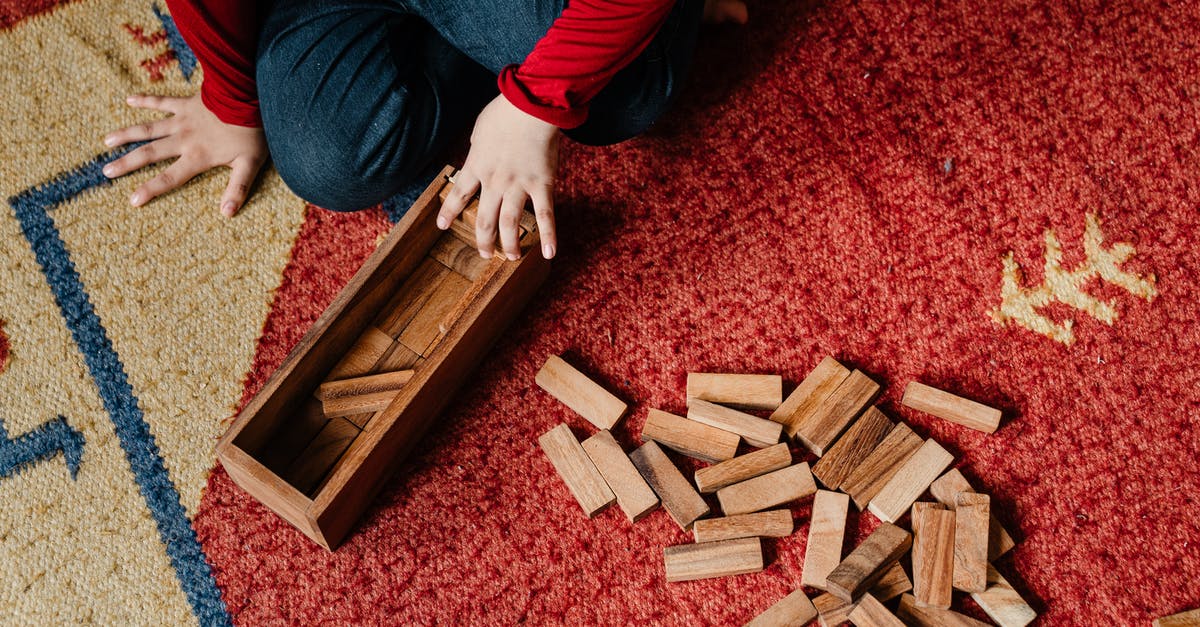 Is it possible for me to build a raised platform that I can put a carpet on? - Unrecognizable child playing jenga at home