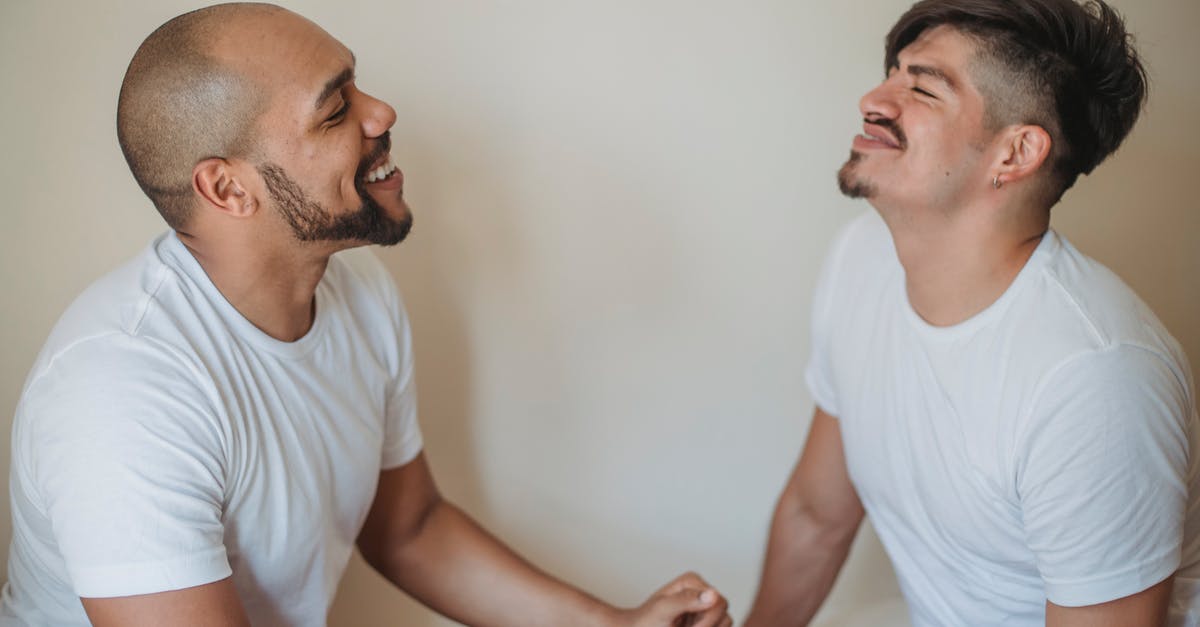 Is it possible for two friends (or two people using the same internet connection) to be matched up against each other in a ranked or unranked game? - Two Men Sitting Opposite Each Other and Smiling