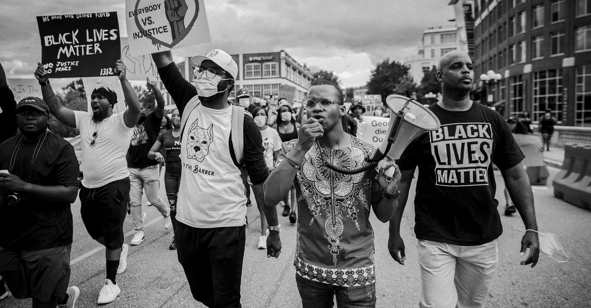 Is it Possible to Access the Loot Chests in Marcus' Bank in the Underdome Riot DLC in Borderlands 1? - Grayscale Photo of People Walking on Street