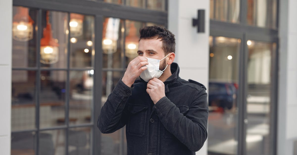 Is it possible to adjust your walk speed? - Young man in medical mask on urban street during Coronavirus pandemic Is it possible to adjust your walk speed? - Young man in medical mask on urban street during Coronavirus pandemic