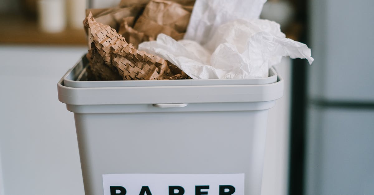Is it possible to clean up rubble, garbage and leaves? - Closeup of plastic container full of paper placed on blurred background of kitchen in daytime