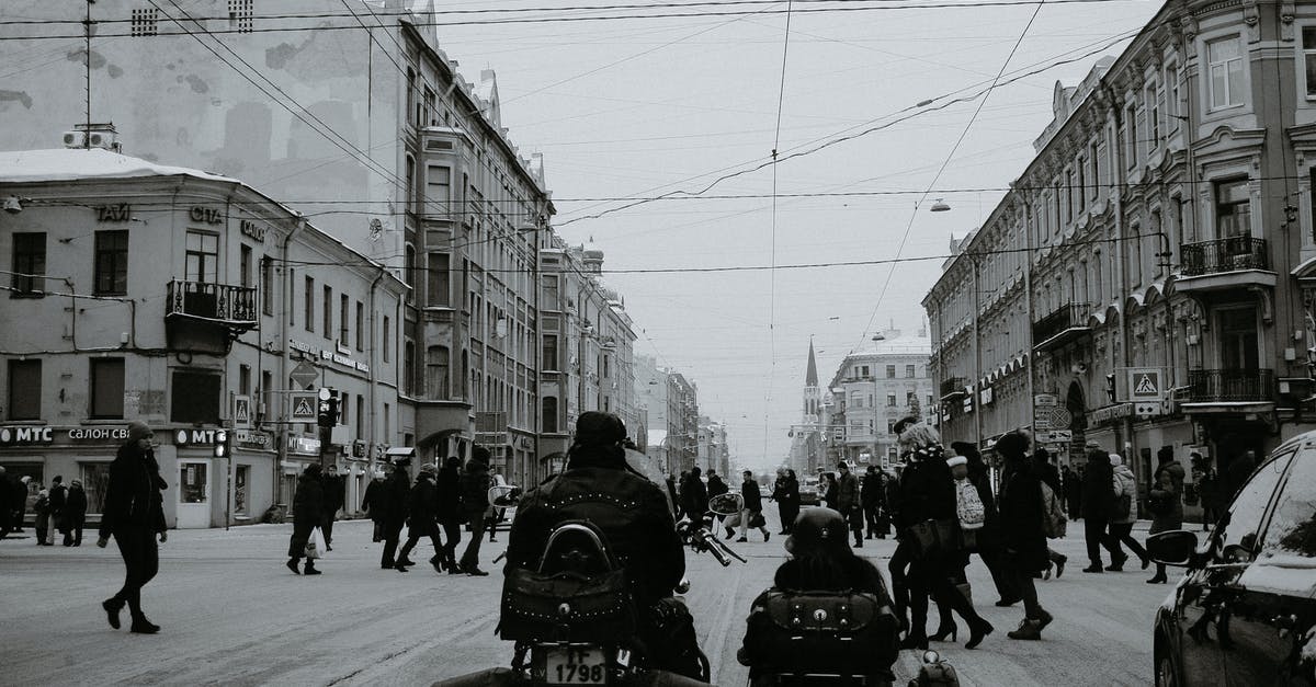 Is it possible to Contain the Traffic Light without stopping? - Black and white of people crossing asphalt road while cars and motorcycle with sidecar waiting for permission signal of traffic light in city in daylight Is it possible to Contain the Traffic Light without stopping? - Black and white of people crossing asphalt road while cars and motorcycle with sidecar waiting for permission signal of traffic light in city in daylight