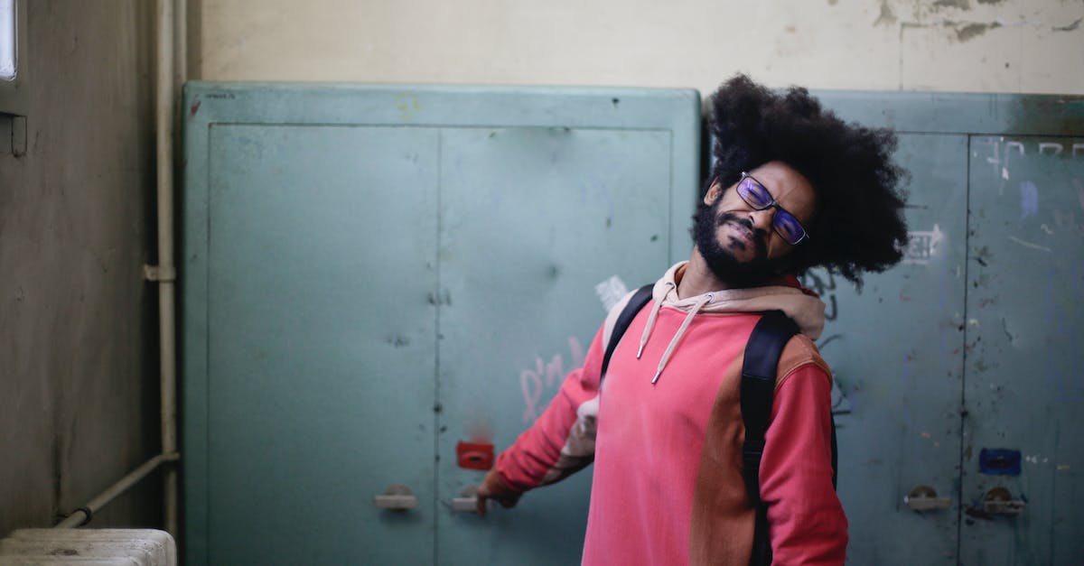 Is it possible to get permanently locked in a room? - Man in Pink and Brown Jacket Standing Beside Gray Locker Door Is it possible to get permanently locked in a room? - Man in Pink and Brown Jacket Standing Beside Gray Locker Door